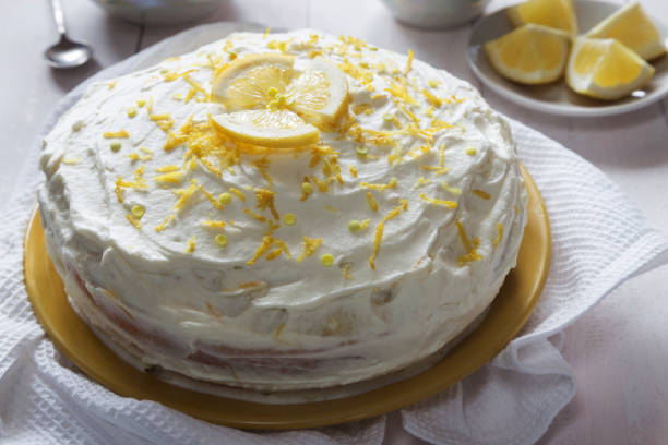 istock Lemon cream sponge cake with zest and a spoon 817513628