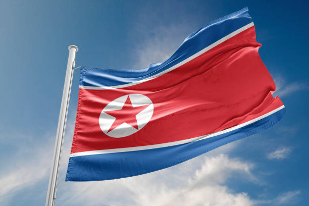 istock North Korea Flag is Waving Against Blue Sky 817514748