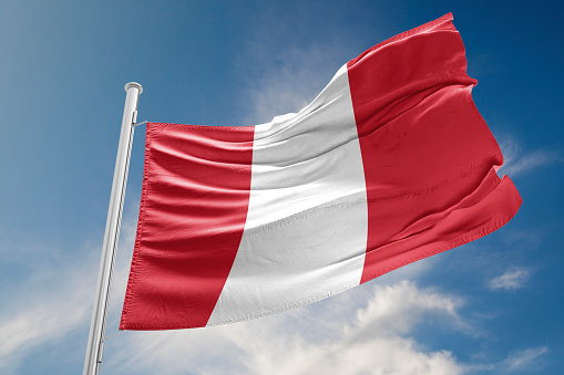 Peru flag is waving at a beautiful and peaceful sky in day time while sun is shining. 3D Rendering