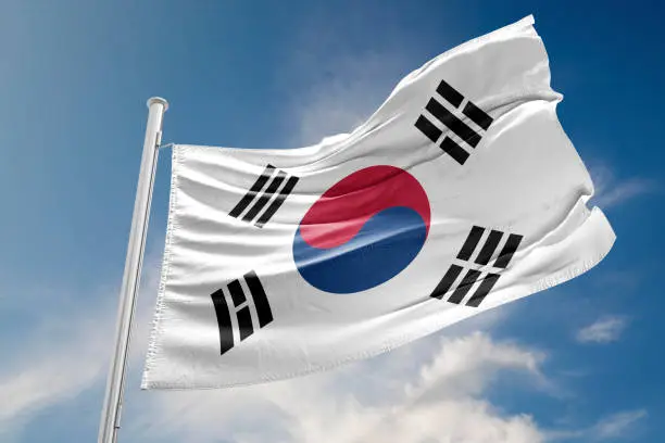 South Korea flag is waving at a beautiful and peaceful sky in day time while sun is shining. 3D Rendering