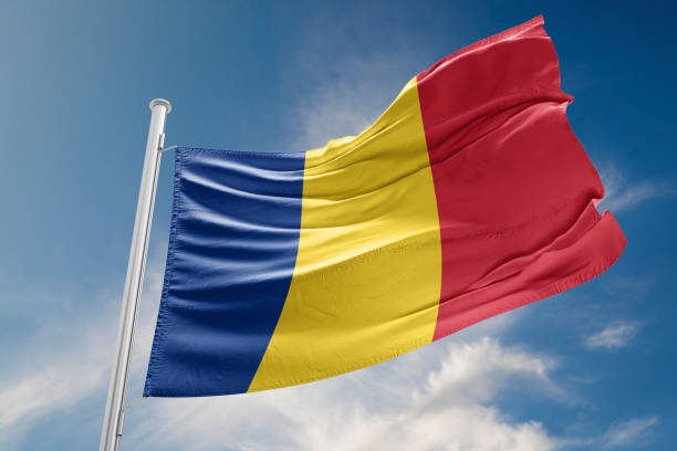 romania flag is waving against blue sky - romania flag romanian flag colors imagens e fotografias de stock