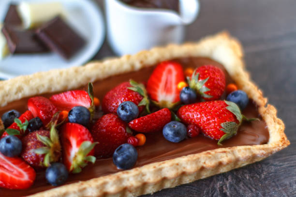 Tart with strawberries, blueberries and chocolate stock photo