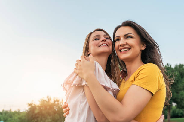 istock Beautiful women smiling and having fun in the park. 817543806