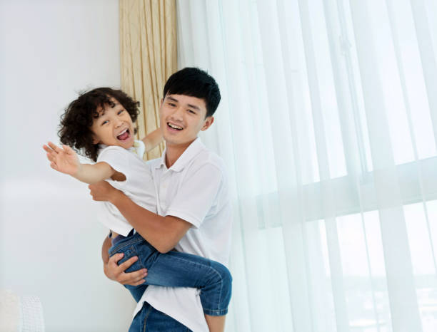 istock Father carrying his son at home 817543968