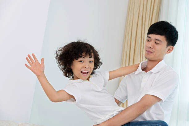 istock Father carrying his son at home 817544160