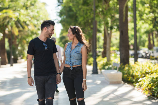 istock Young couple walking together holding hands 817544804
