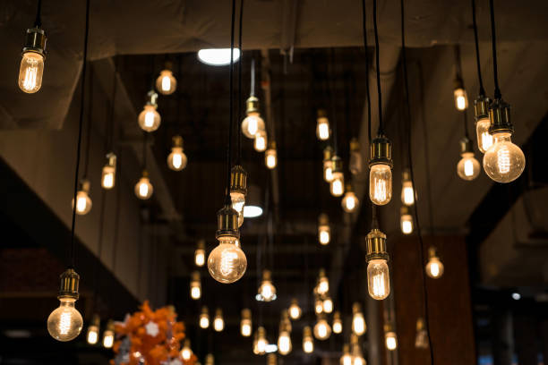 istock light bulbs hanging by long wire. Interior decoration 817549336