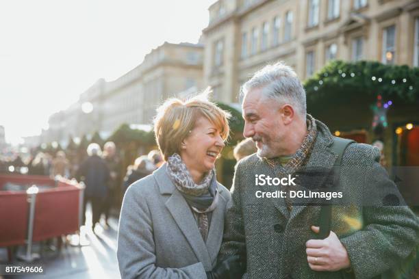 Mature Couple In Christmas Market Stock Photo - Download Image Now - Christmas, Winter, Retail