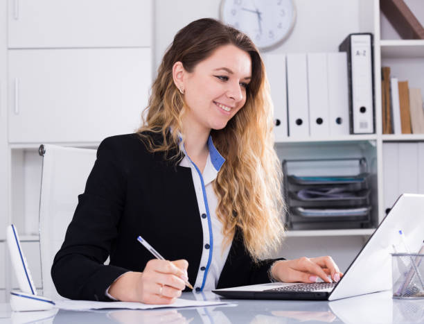 istock Young and smiling businesswoman in jacket 817552962