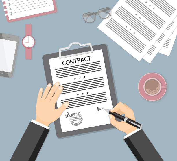 istock signing contract with glasses, wristwatch, mobile phone, coffee cup 817560292