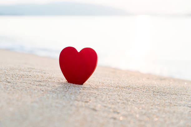 istock Red heart shape on the beach 817568844