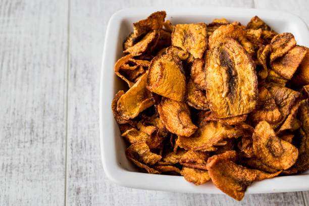 istock Dried Carrot Chips on white wooden surface. 817577632