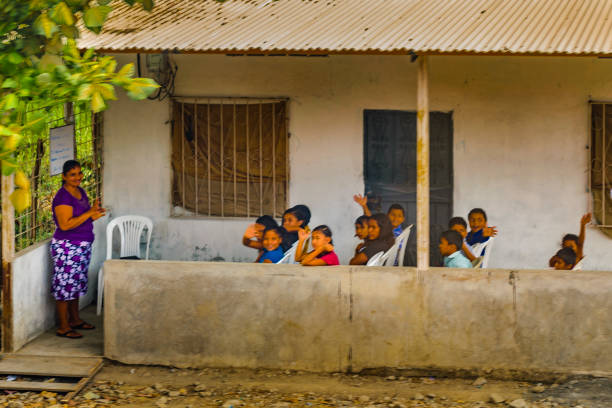 GUAYAS, ECUADOR, OCTOBER - 2016 - Group of student and teacher saying hello to the camera in poor rural town in Guayas district, Ecuador