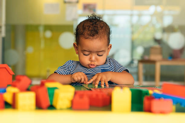 istock Happy baby playing with toy blocks. 817588478