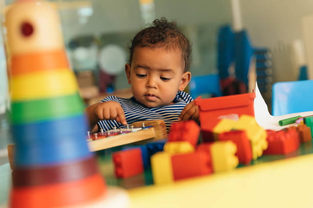 istock Happy baby playing with toy blocks. 817588482