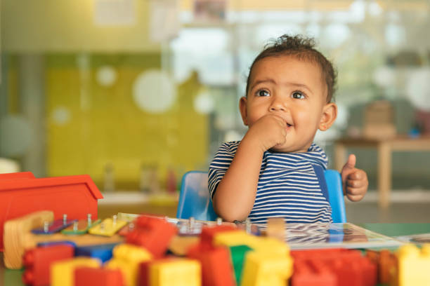 istock Happy baby playing with toy blocks. 817588502