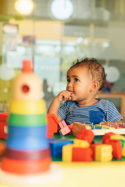 istock Happy baby playing with toy blocks. 817588506