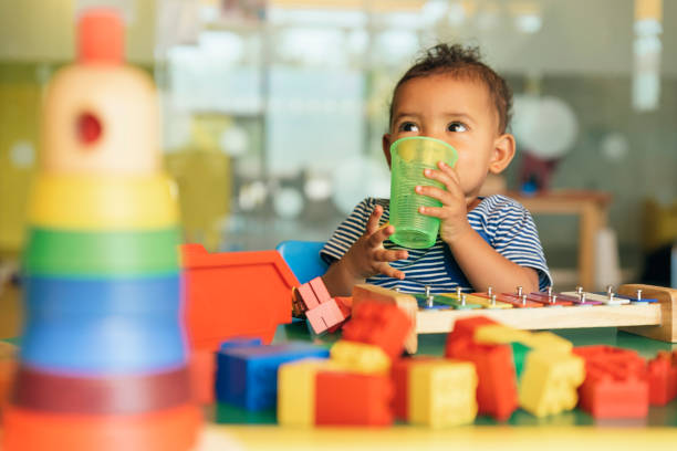istock Happy baby drinking water and playing. 817588530