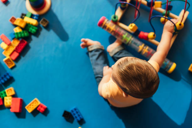 istock Happy baby playing with toy blocks. 817588600