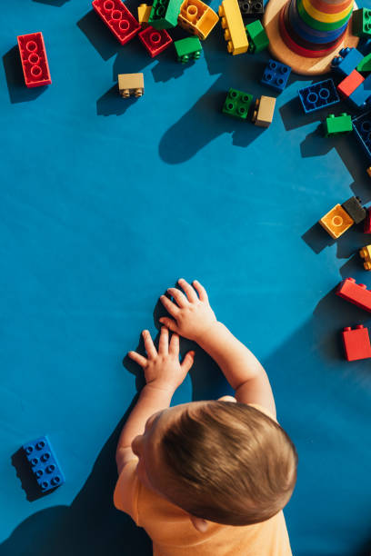 istock Happy baby playing with toy blocks. 817588748