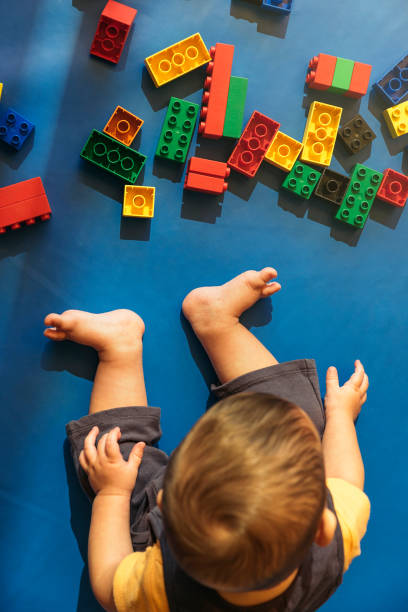 istock Happy baby playing with toy blocks. 817588754