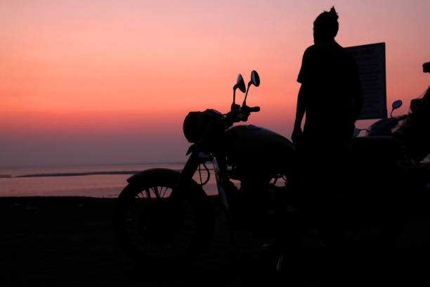 istock Young man standing near motorbike . 817589264