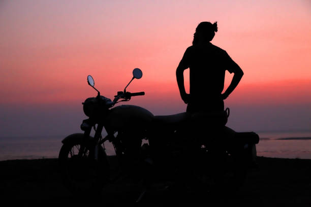 istock Young man standing near motorbike . 817589752