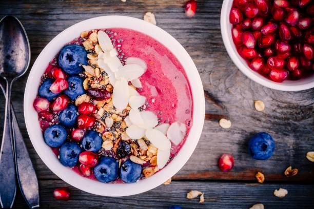 istock Raspberry smoothie bowl with granola, chia seeds, almonds, fresh blueberries and pomegranate 817611266