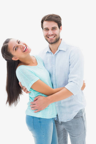 istock Attractive young couple hugging and smiling at camera 817611382