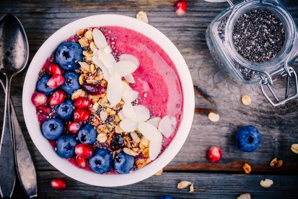 istock Raspberry smoothie bowl with granola, chia seeds, almonds, fresh blueberries and pomegranate 817613702