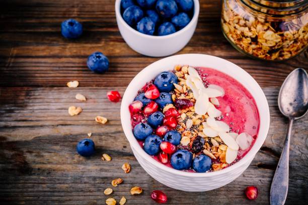 istock Raspberry smoothie bowl with granola, chia seeds, almonds, fresh blueberries and pomegranate 817616162