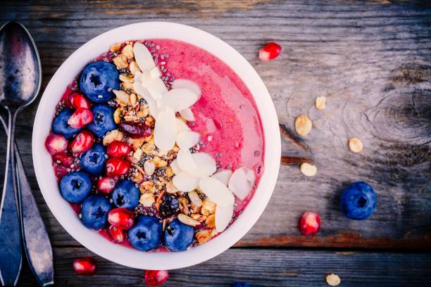istock Raspberry smoothie bowl with granola, chia seeds, almonds, fresh blueberries and pomegranate 817616496