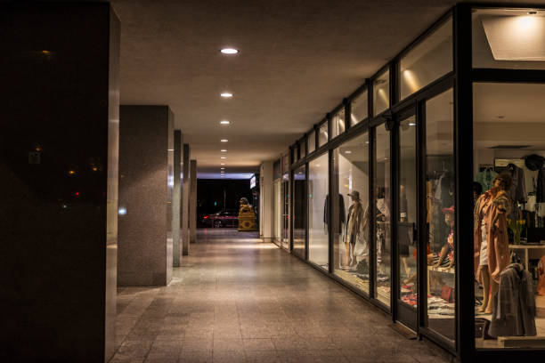 Berlin: Hallway with clothes shops illuminated at night in Berlin, Germany