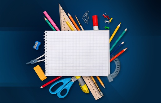 Colorful school supplies on wooden background