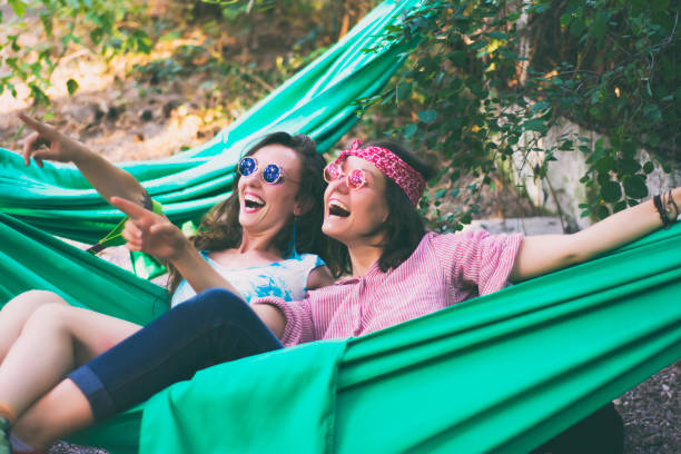 Young cheerful women in a hammock
