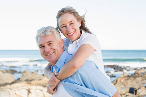 istock Casual couple having fun by the sea 817646646