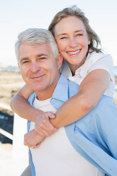 istock Casual couple having fun by the sea 817646820