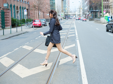 Woman crossing street in profile