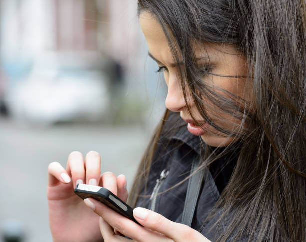 istock Hispanic woman using mobile phone, exploring Dusseldorf 817647392