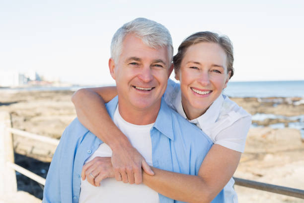 istock Casual couple having fun by the sea 817647506