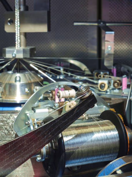 istock Manufacture of metal shielding braids for electrical cables. High-speed braiding machine. Winding the finished braid over the reel. 817649376