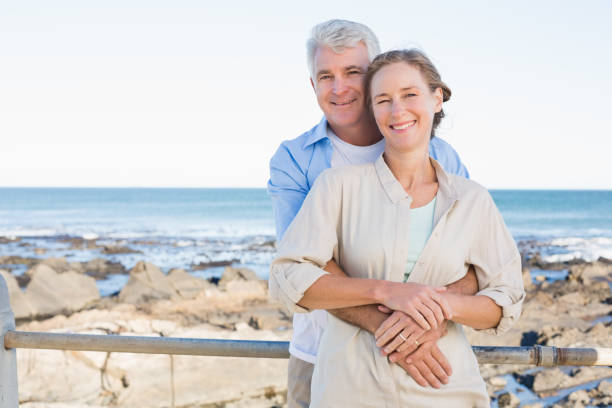 istock Happy casual couple hugging by the coast 817649380