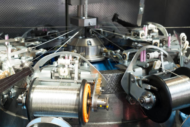 istock Manufacture of metal shielding braids for electrical cables. High-speed braiding machine. Winding the finished braid over the reel. 817649488