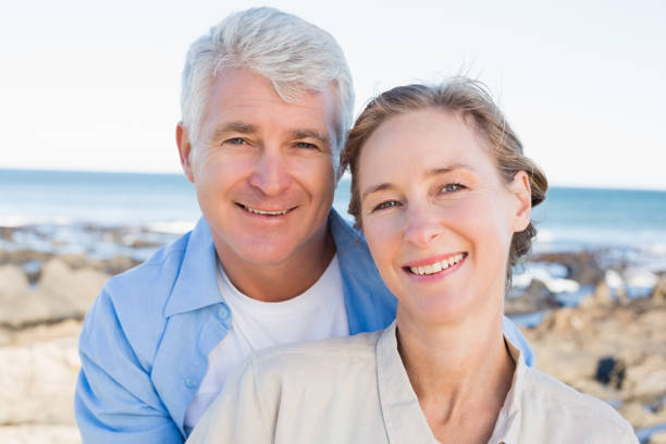 istock Happy casual couple by the coast 817649494