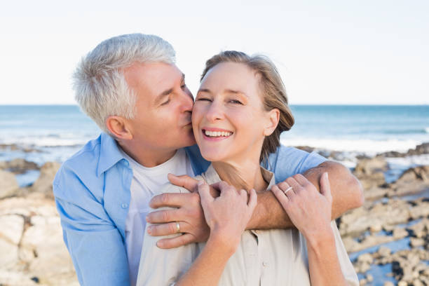 istock Happy casual couple by the coast 817651724