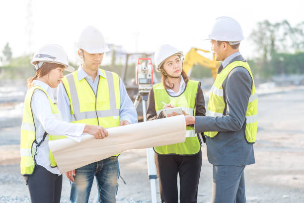 istock Businessman engineer and builder review blueprint during team meeting at construction site 817654672