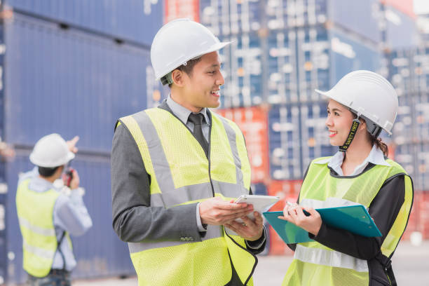 istock businessman in logistic, export, import industry with shipping cargo container freight in background. 817654826