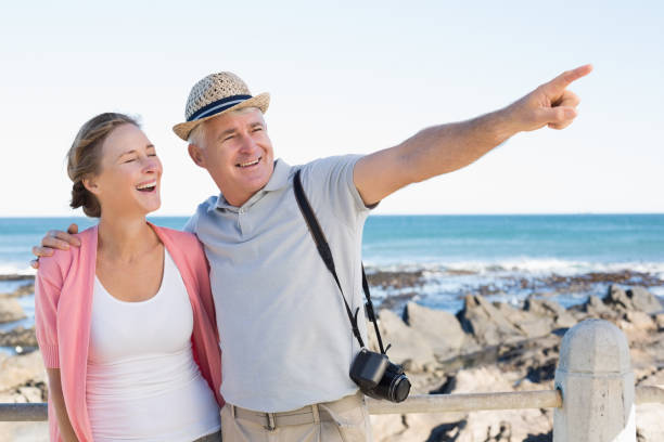 istock Happy casual couple looking at something by the coast 817656162