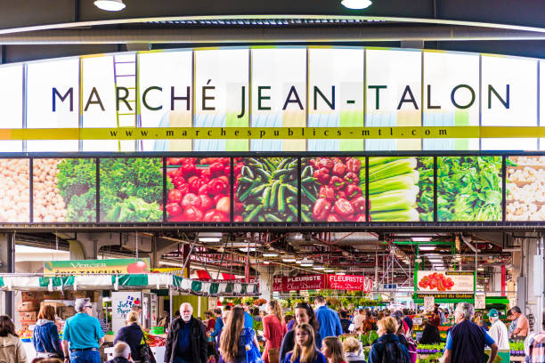 Jean Talon market sign and entrance with people in Little Italy neighborhood in city in Quebec region Montreal
