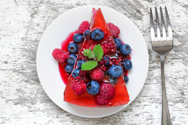 istock Delicious cheesecake with fresh berries and mint on a plate with fork 817671530